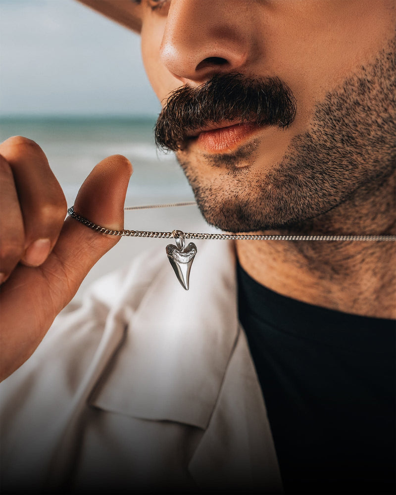 Man wearing a silver pendant necklace