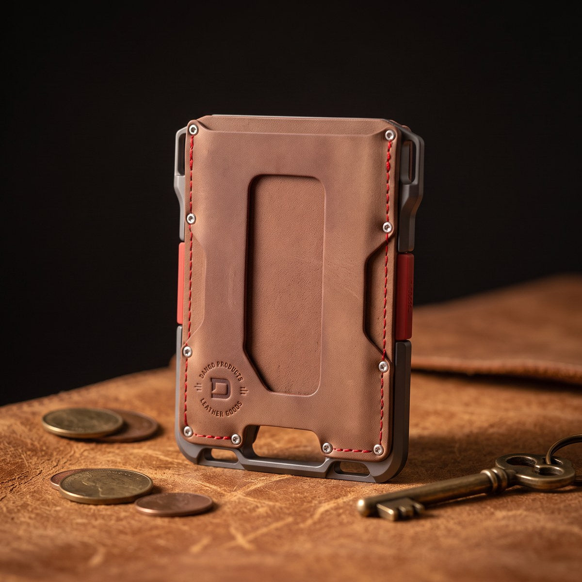 Leather card wallet on a worn leather surface with coins and a key at XSREZ