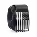 Black tactical web belt with American flag buckle, textured strap and metal keeper