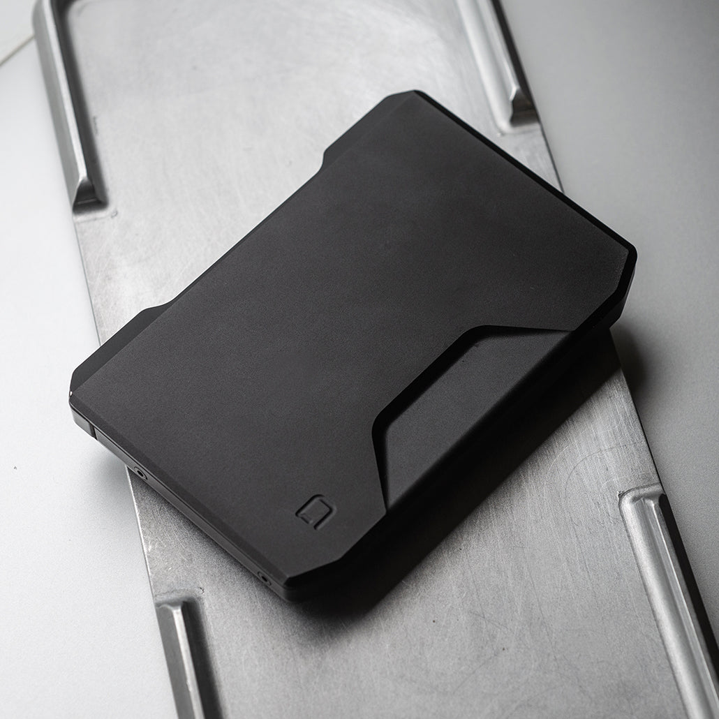 Jet black slide kick wallet with kick-out card tray, front view
