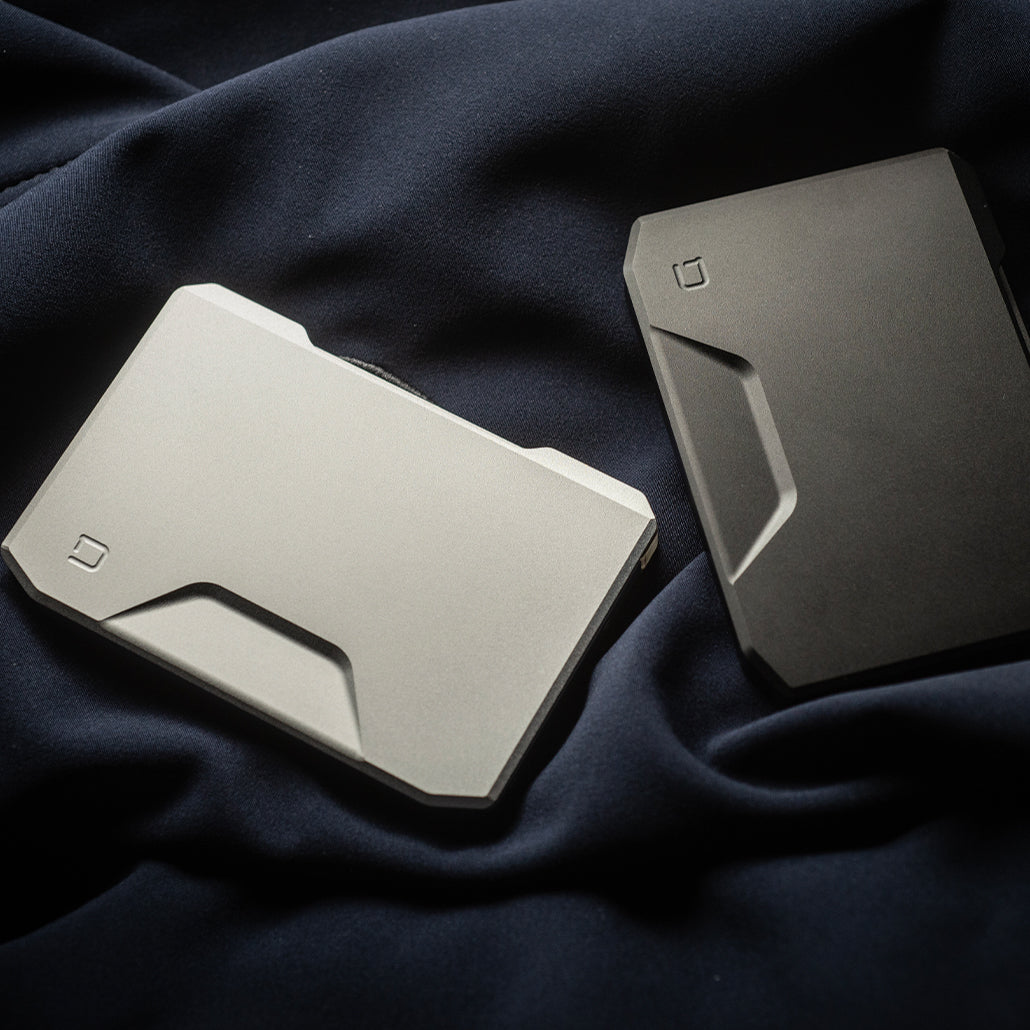 Dango SK1 Slide Kick Wallets in silver and dark finishes, shown from the kickstand side