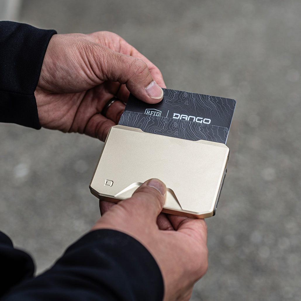 Satin silver Dango SK1 Slide Kick Wallet dispensing a card