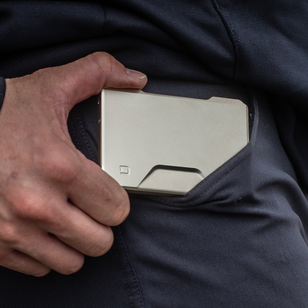 Satin silver Dango SK1 Slide Kick Wallet tucked into a pocket