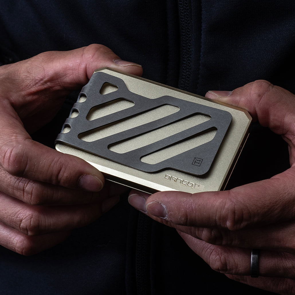 Champagne gold slide kick wallet with textured grip panel held in hands
